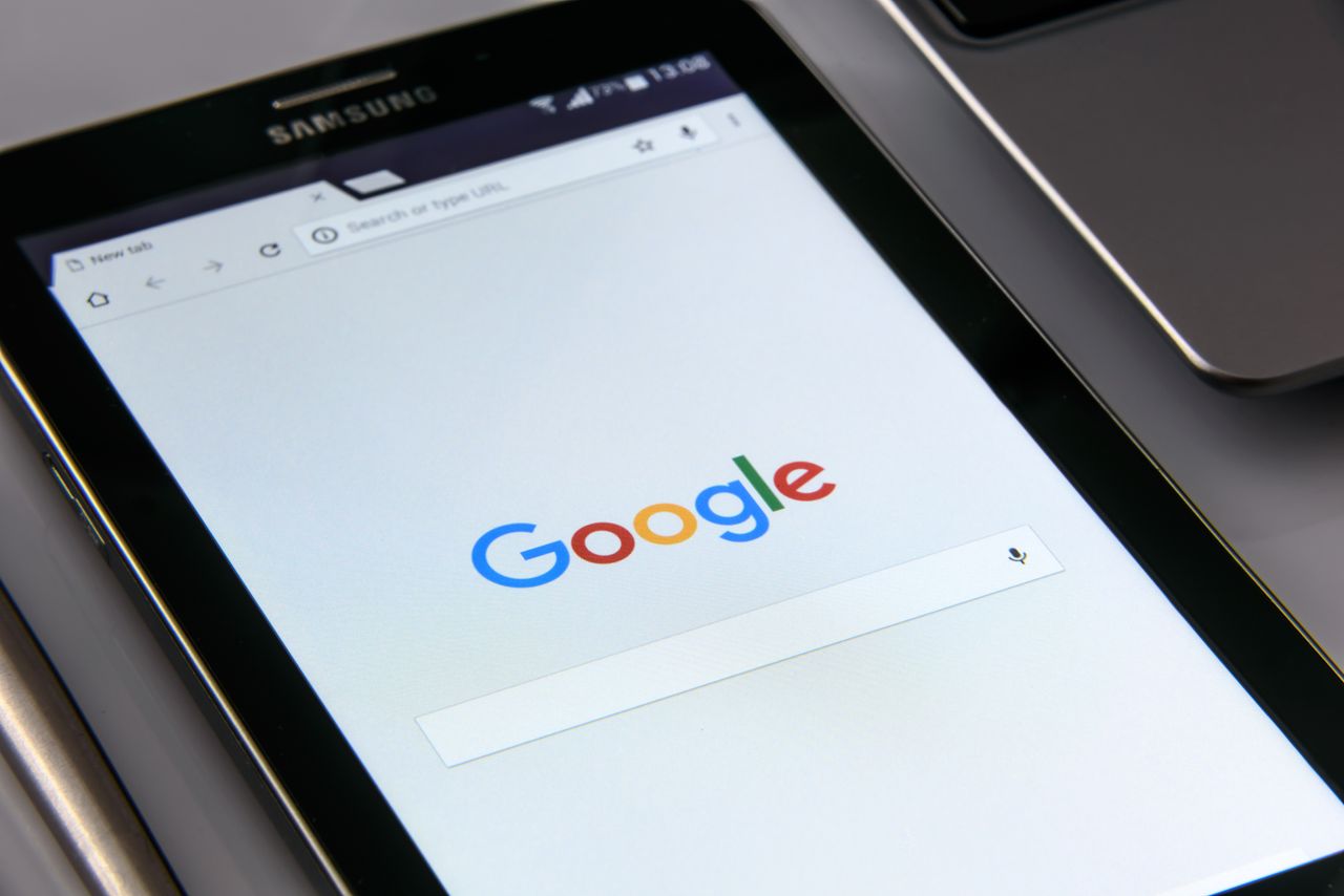 heros-img Close-up of a tablet displaying Googles search screen, emphasizing technology and internet browsing.